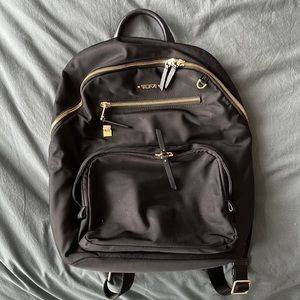 Tumi black backpack with gold details